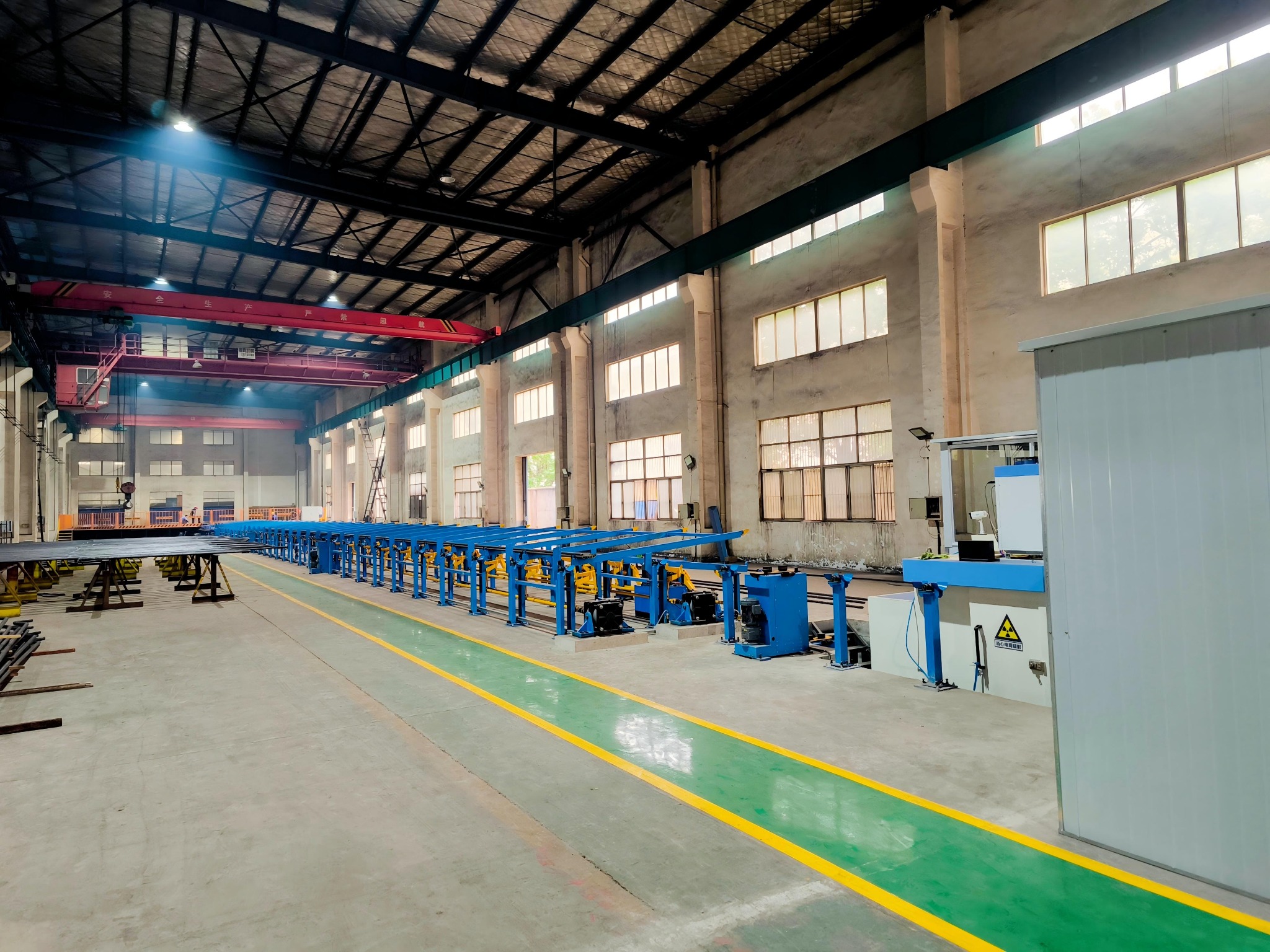 Factory workshop with production equipment and overhead cranes
